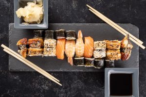 healthy-delicious-variety-sushi-dark-stone-background-top-view