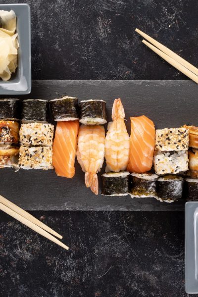 healthy-delicious-variety-sushi-dark-stone-background-top-view